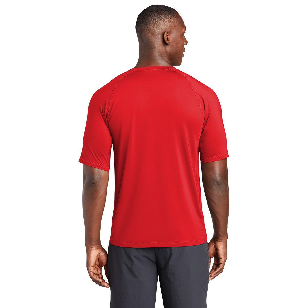 Man wearing the red Mencity Fight Camp rashguard tee, back view