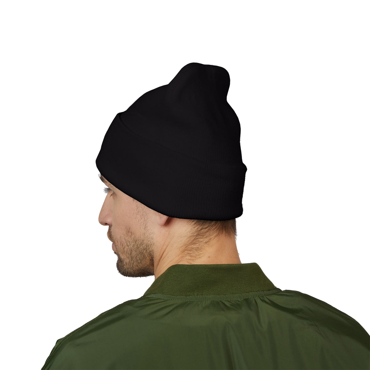 Man wearing the black Mencity cuffed beanie, back view, with a green jacket